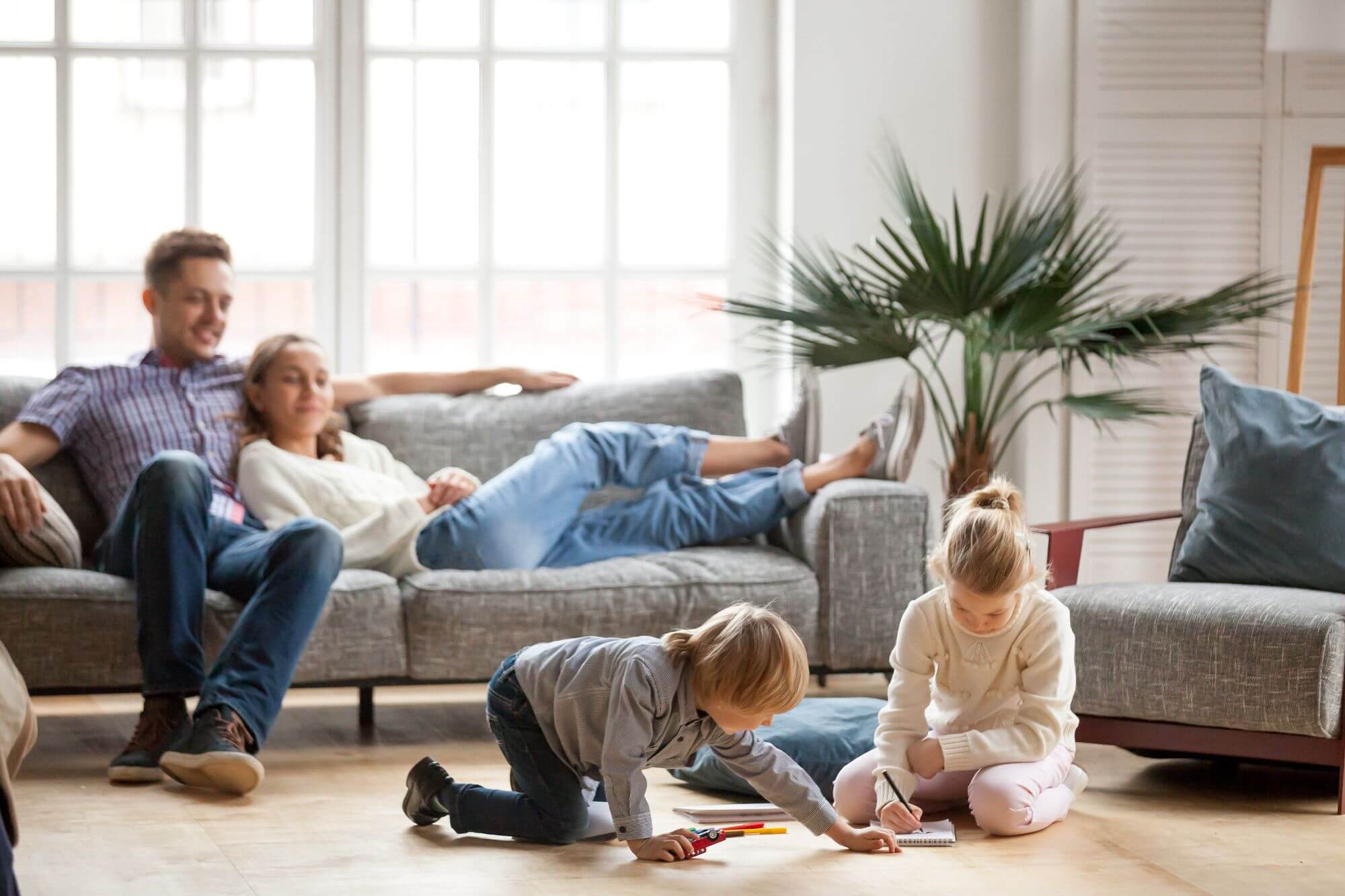 Family in living room assessing need for residential radon testing
