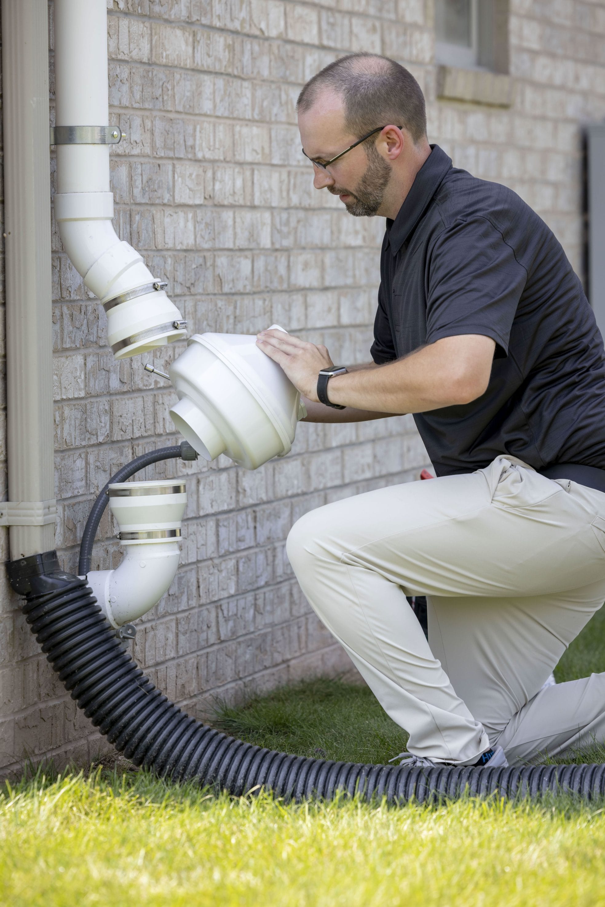 Technician Inspecting Radon System for Repair

