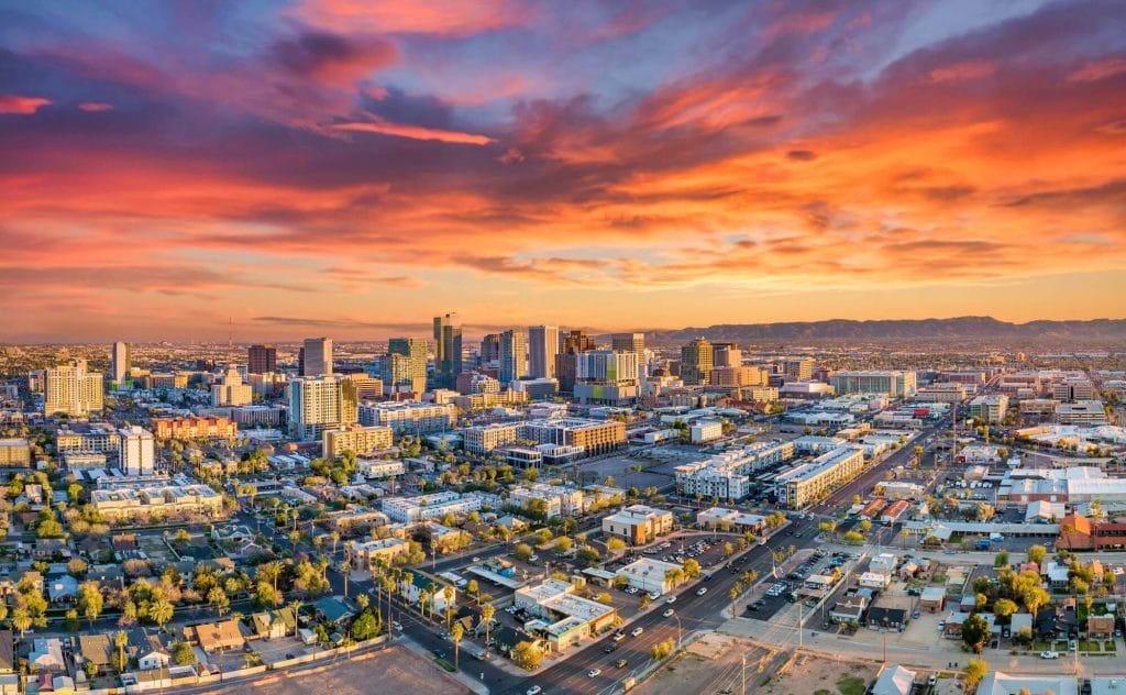 Aerial view of cityscape at sunset suitable for commercial radon mitigation

