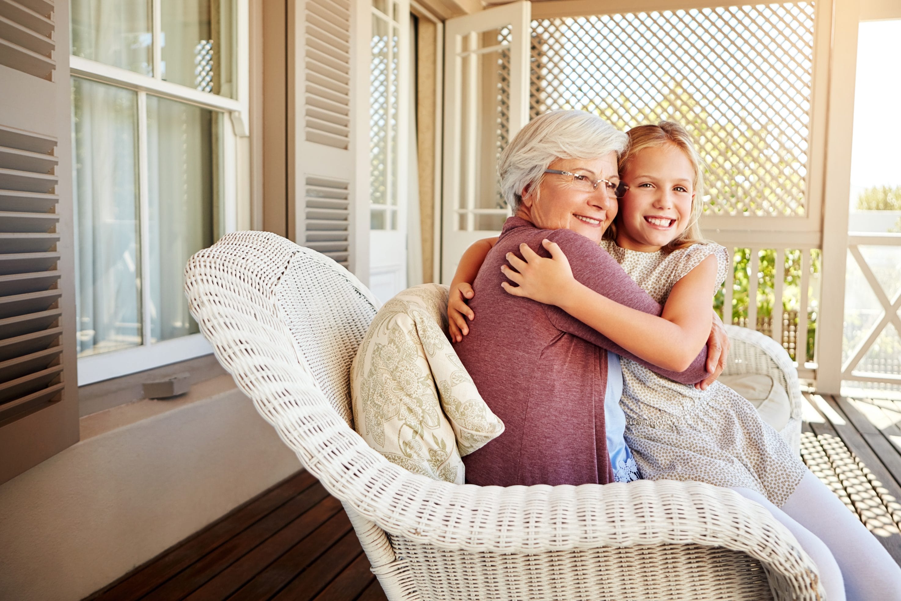 Family hugging on a porch in a radon-free Texas home. 
