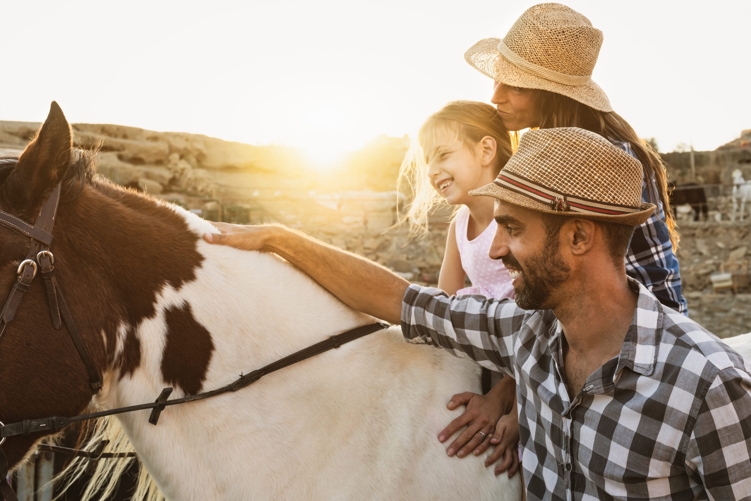 Family Enjoying Horseback Riding in Texas at Sunset
