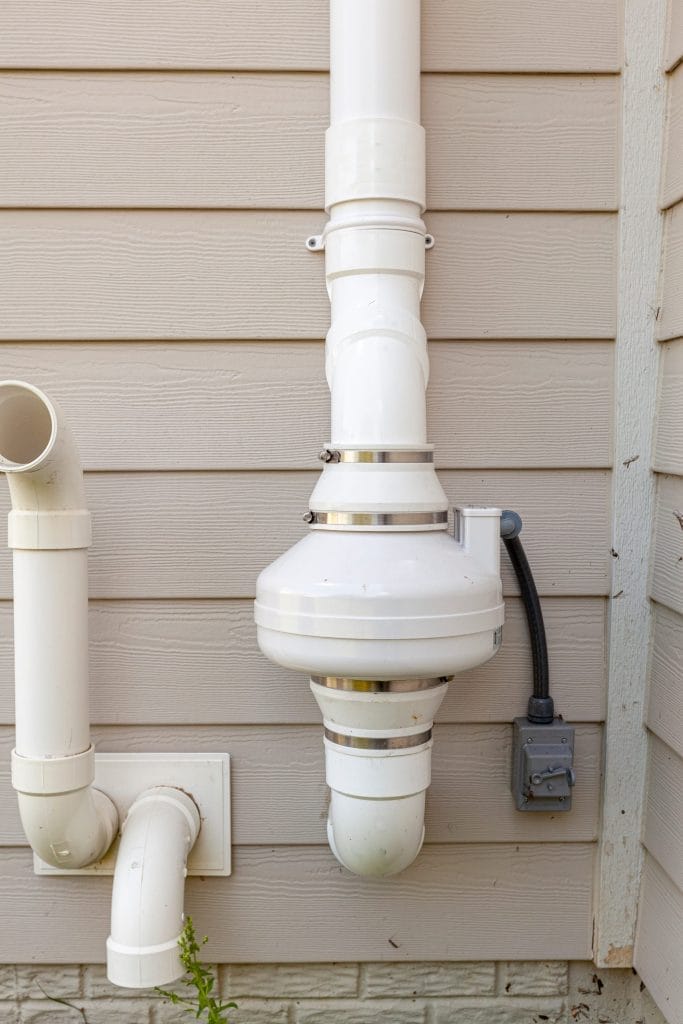Radon mitigation system installed on house exterior in Arizona

