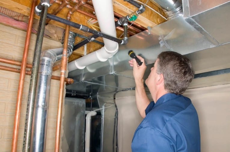 Man Conducting Residential Radon Testing in Arizona Basement
